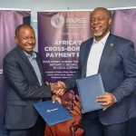 Gituku Kirika (left), CEO, Pesalink, and Mike Ogbalu (right), CEO, PAPSS, during the official partnership signing at IPSL offices in Nairobi, Kenya