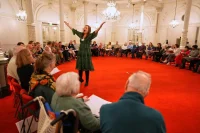 People, many of them seniors with a form of dementia, join in the "singing circle" run by opera singer Maartje de Lint, at the Concertgebouw's ornate Mirror Hall in Amsterdam on Feb. 24, 2026. (AP Photo/Peter Dejong) (ASSOCIATED PRESS)