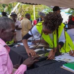 A Kenyan being registered as a voter
