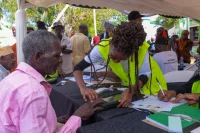 A Kenyan being registered as a voter