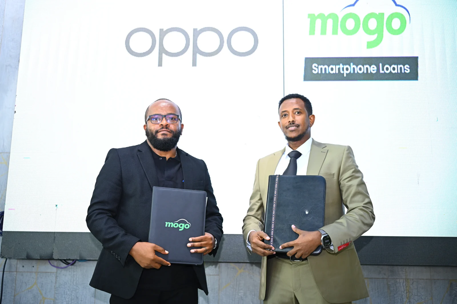 Mogo Head of Device Sales, Fred Muoka, together with OPPO Kenya's National Distributor, Deeq Bure, at the official MoU signing ceremony. PHOTO | Business Today.