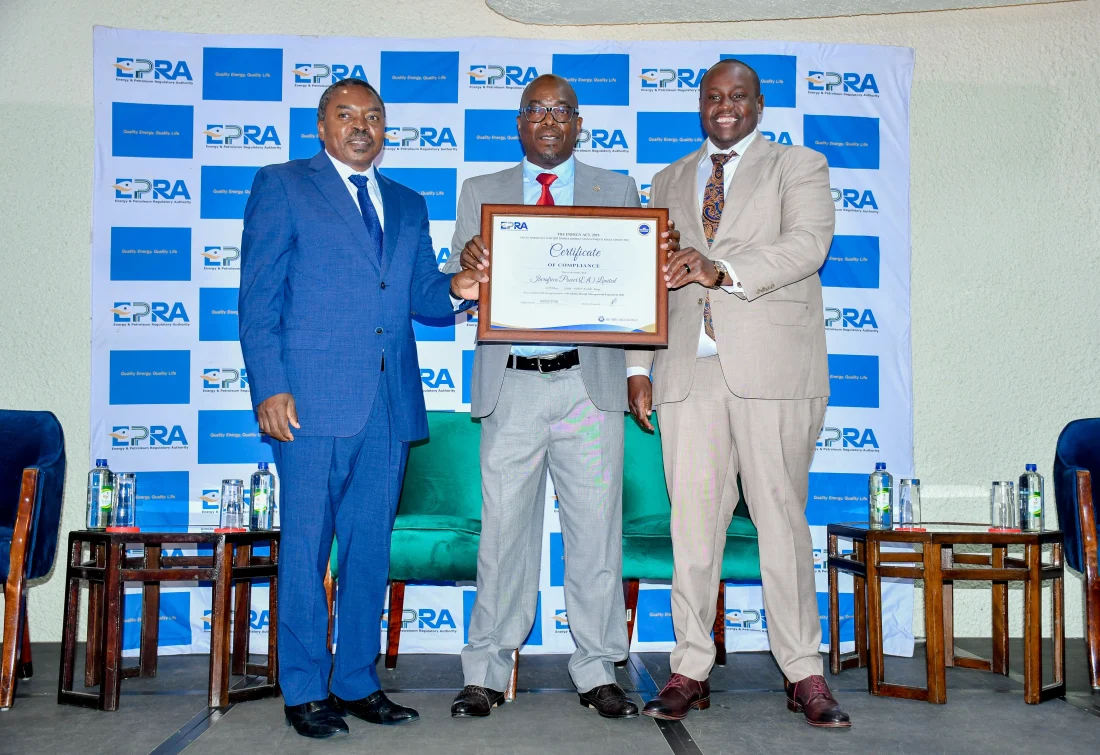 Eng Isaac Kiva, Secretary for Renewable Energy in the State Department of Energy(Left) joins Mr Daniel Kiptoo, Director General at the Energy and Petroleum Regulatory Authority(Right) to present a certificate of compliance on Energy Management to Mr Michael Nyangi , the Chief Financial Officer Iberaafrica Power (E.A) LTD. (Courtesy)