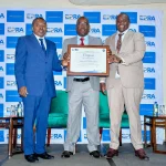 Eng Isaac Kiva, Secretary for Renewable Energy in the State Department of Energy(Left) joins Mr Daniel Kiptoo, Director General at the Energy and Petroleum Regulatory Authority(Right) to present a certificate of compliance on Energy Management to Mr Michael Nyangi , the Chief Financial Officer Iberaafrica Power (E.A) LTD. (Courtesy)