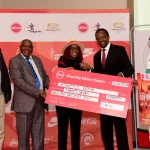 Absa Bank Kenya Marketing and Corporate Affairs Director Mwihaki Wachira (Centre) presents the sponsorship cheque Competition Director Kennedy Tanui, Vice President Jinaro Kibet (2nd Right), Competition Director Kennedy Tanui, Senior Vice President Paul Mutwii, and Meet Director Barnabas Korir during the Absa Kip Keino Classic