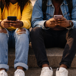 Teenagers with smartphones on concrete steps