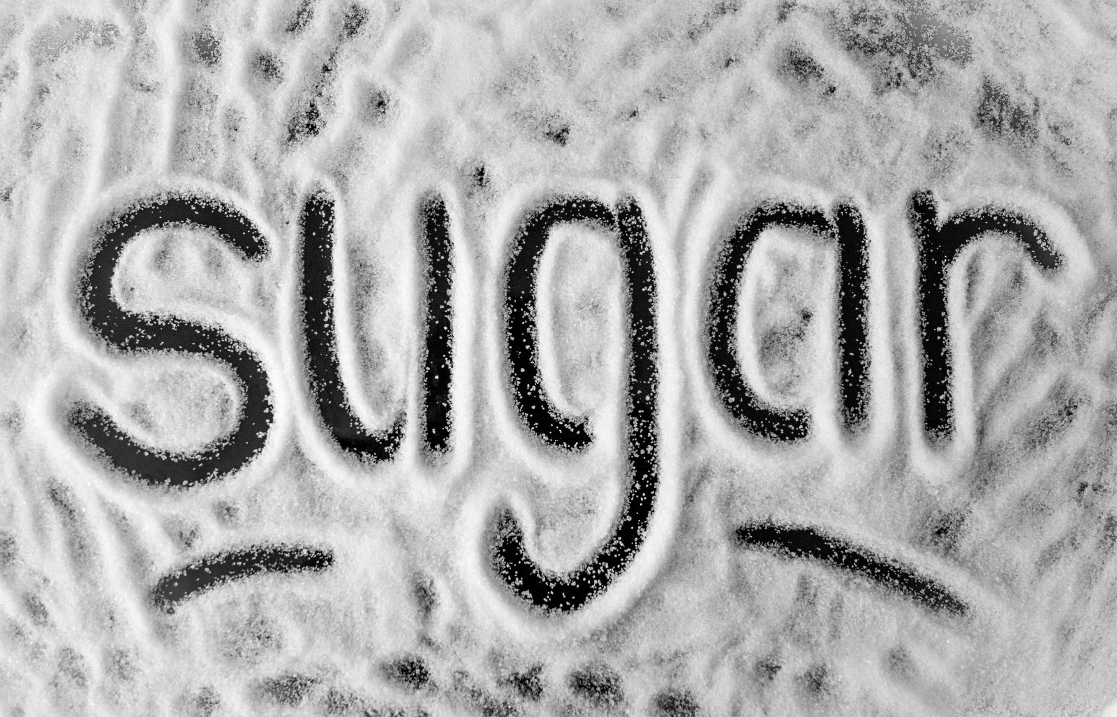 The word 'sugar' written in powder,