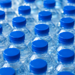 Blue-capped water bottles in grid pattern