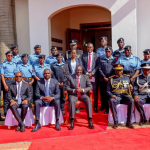 President William Ruto and other senior government officials pose for a photo with police officers wearing new uniform.