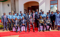 President William Ruto and other senior government officials pose for a photo with police officers wearing new uniform.