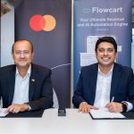 Shehryar Ali, senior vice president and country manager for East Africa and Indian Ocean Islands at Mastercard (left), and Saad Latif, Director of Commercial Operations at Flowcart, sign a strategic collaboration agreement to enable secure, seamless card payments within social and conversational commerce journeys across East Africa.