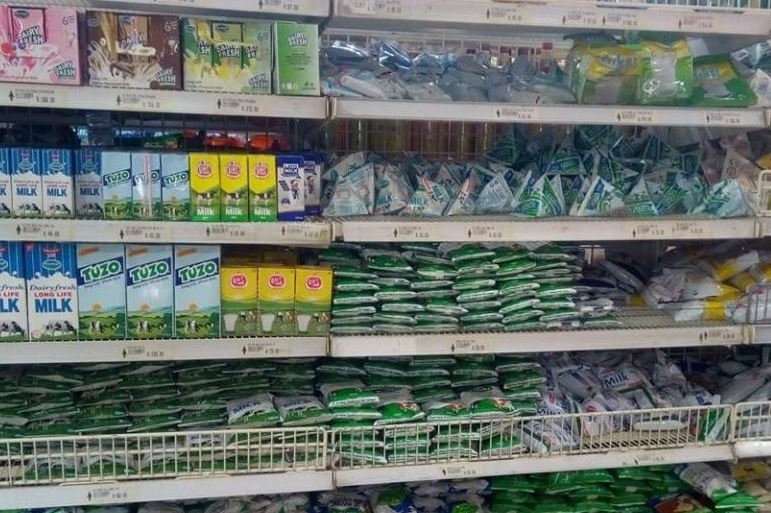 Milk on display in supermarket shelves