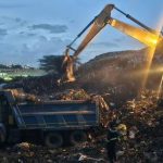 Waste operators working at dawn.